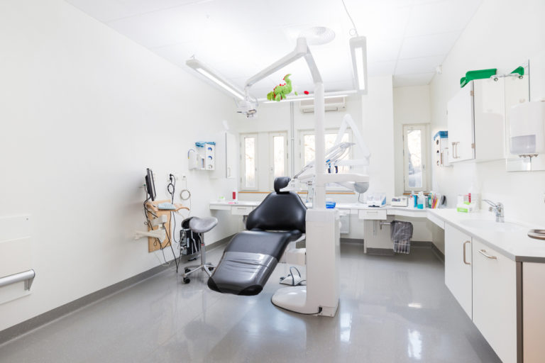 Photo of a dental chair inside of a dental surgery